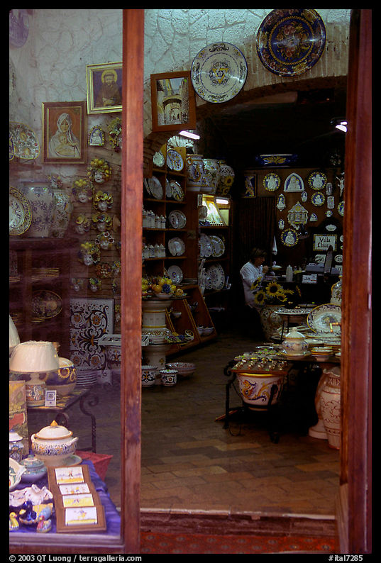 Woman painting plates in a ceramic store. Orvieto, Umbria