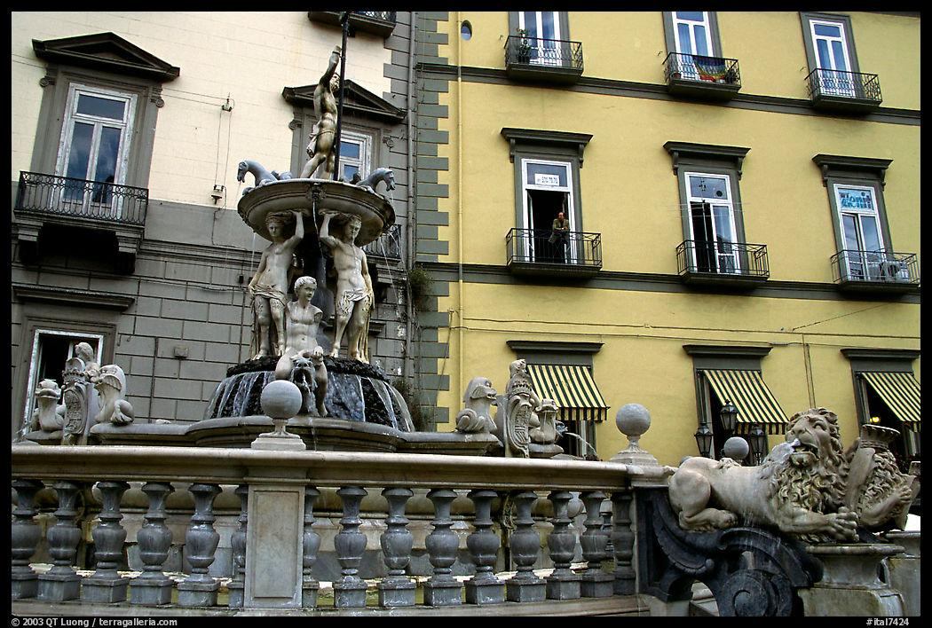 Fountain with man at balcony in background. Naples, Italy