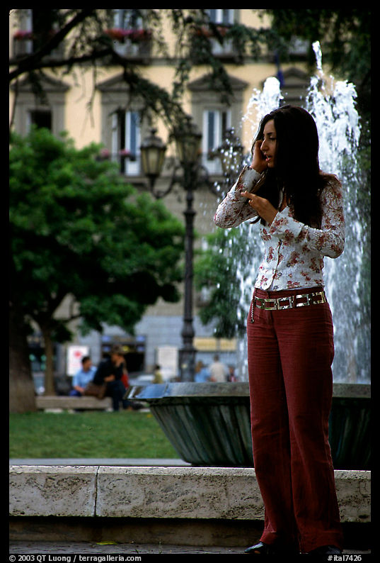Young woman talking on a cell phone. Naples, Italy