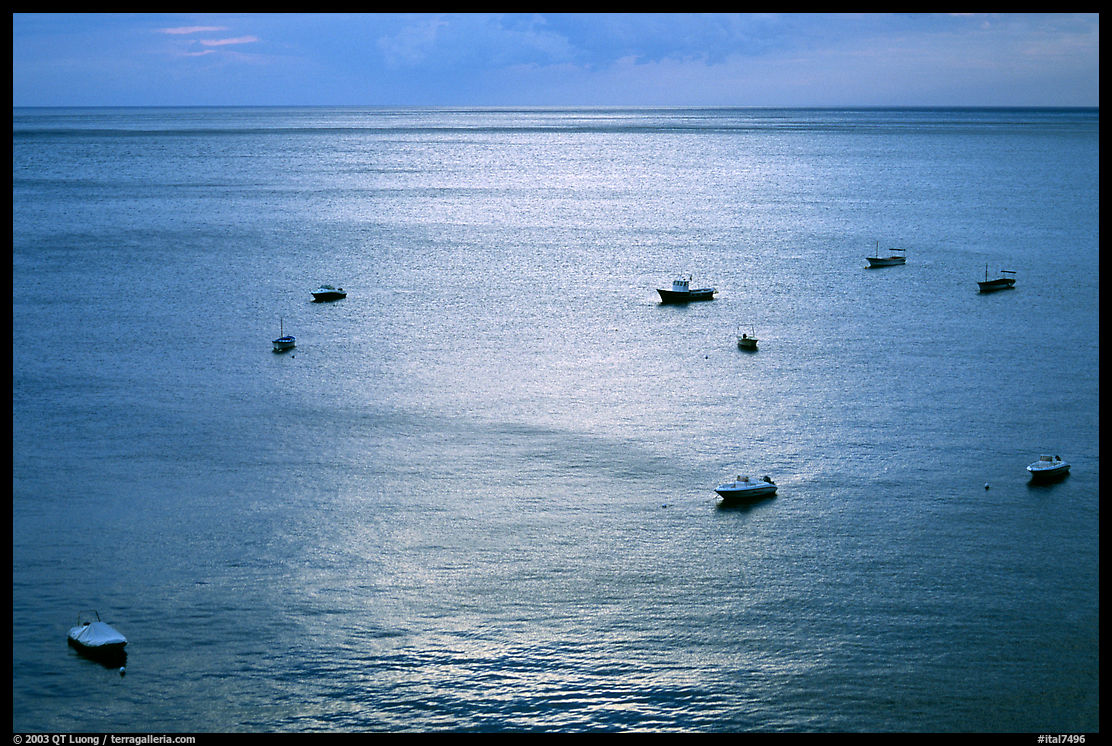 Small boats at sunset in the Gulf of Salerno, Positano. Amalfi Coast, Campania, Italy