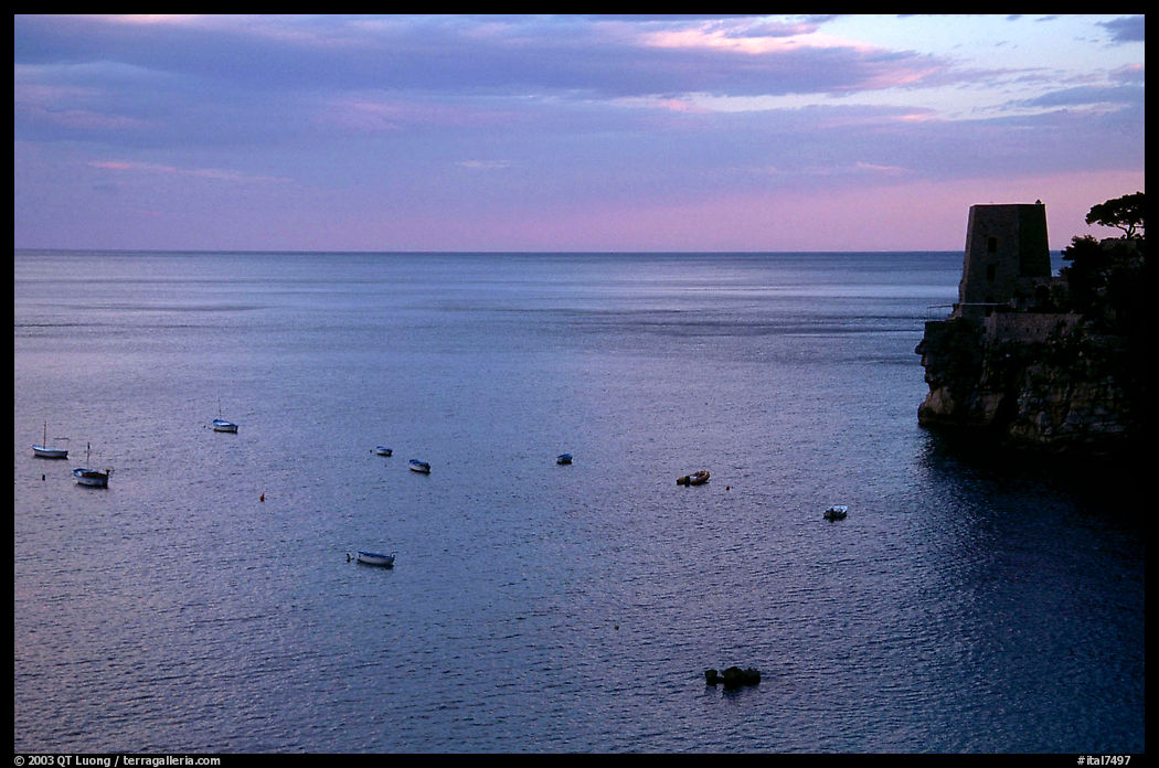 Small boats and tower and sunset, Positano. Amalfi Coast, Campania, Italy