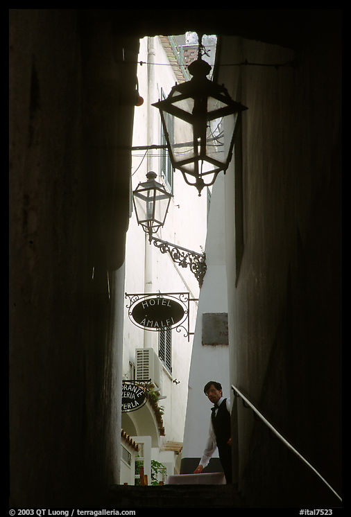 Narrow stairway with formally dressed man and hotel sign,  Amalfi. Amalfi Coast, Campania, Italy