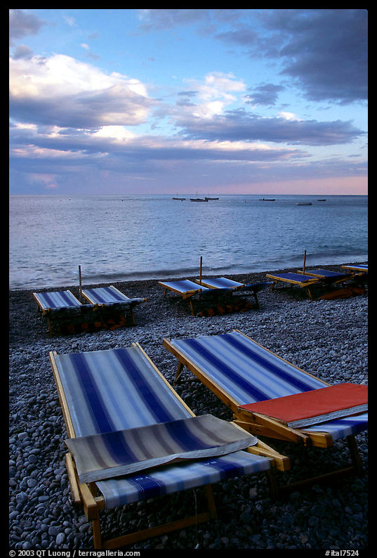 Beach chairs on Spiaggia del Fornillo at sunset, Positano. Amalfi Coast, Campania, Italy