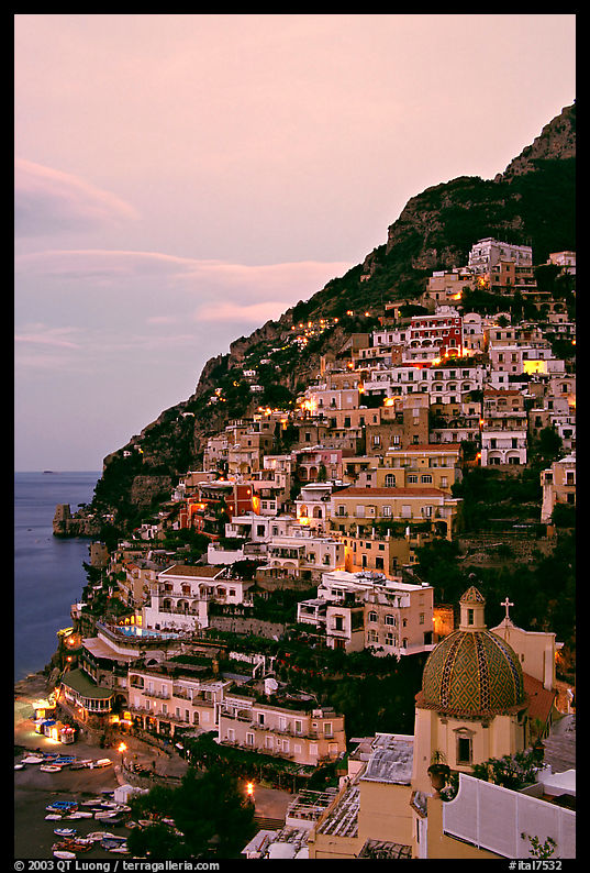 Positano at dawn, with the ceramic dome of Chiesa di Santa Maria Assunta in the foreground. Amalfi Coast, Campania, Italy
