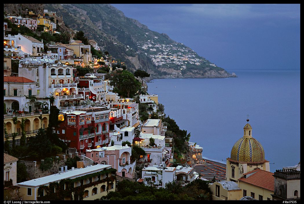 Chiesa di Santa Maria Assunta and houses on steep hills at dusk, Positano. Amalfi Coast, Campania, Italy