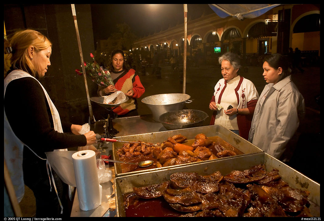 Women buying food at a food stand by night, Tlaquepaque. Jalisco, Mexico