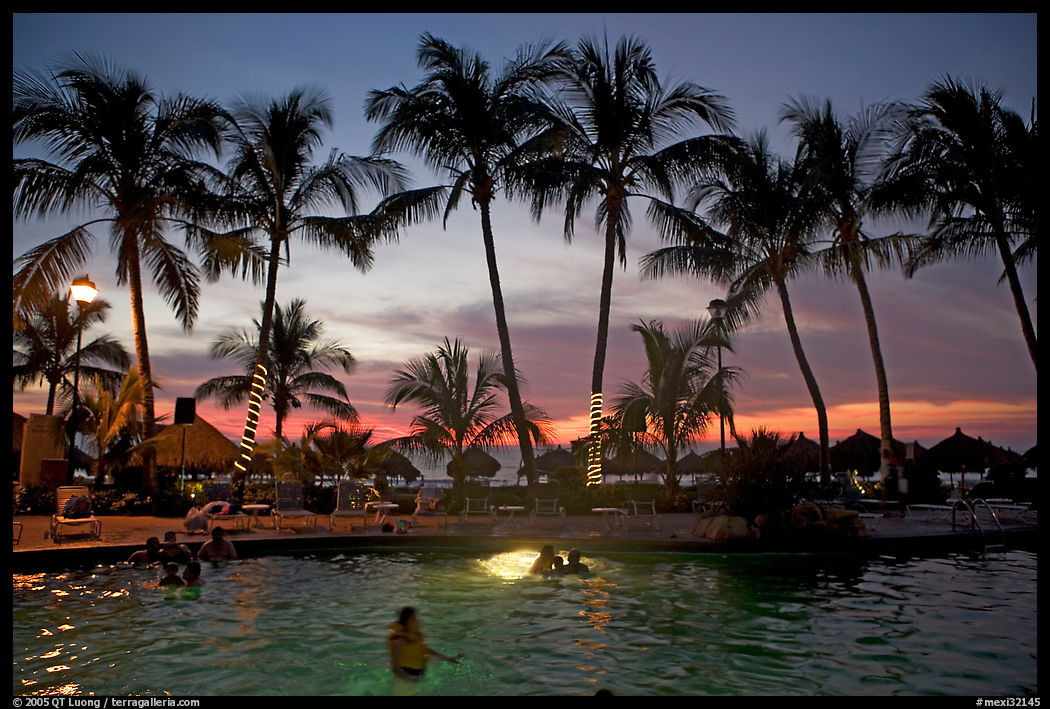 Palm-tree fringed swimming pool at sunset, Nuevo Vallarta, Nayarit. Jalisco, Mexico