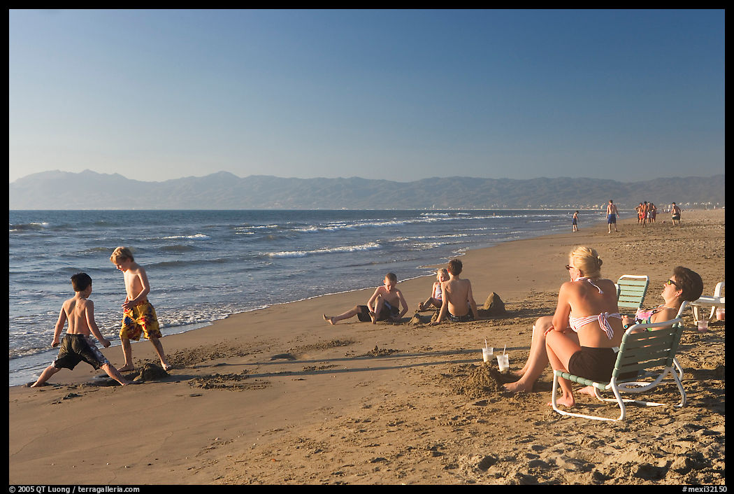 Mothers sitting on beach chairs watching children play in sand, Nuevo Vallarta, Nayarit. Jalisco, Mexico