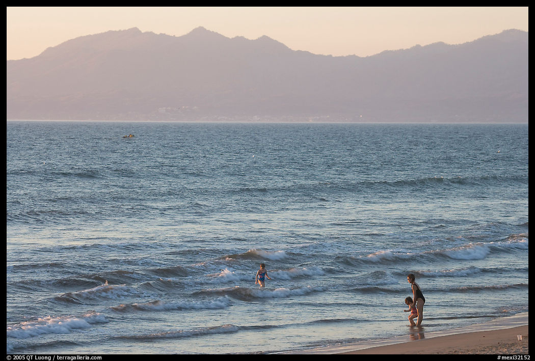 Woman holding children on the beach at sunset, Nuevo Vallarta, Nayarit. Jalisco, Mexico