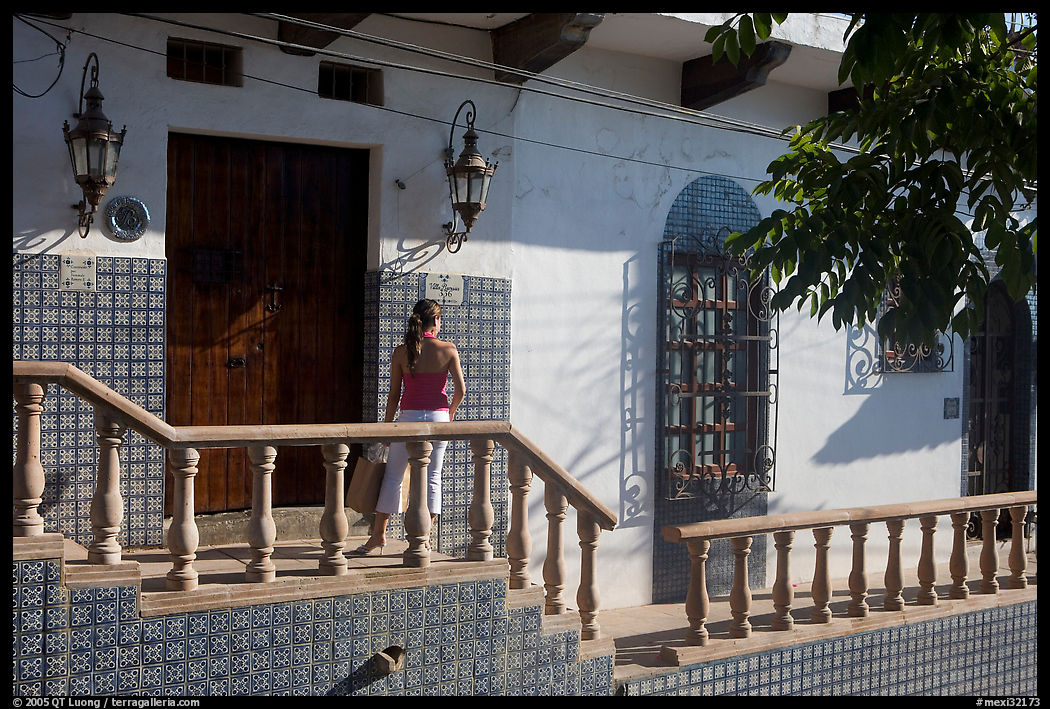 Woman waiting at the door of a house, Puerto Vallarta, Jalisco. Jalisco, Mexico