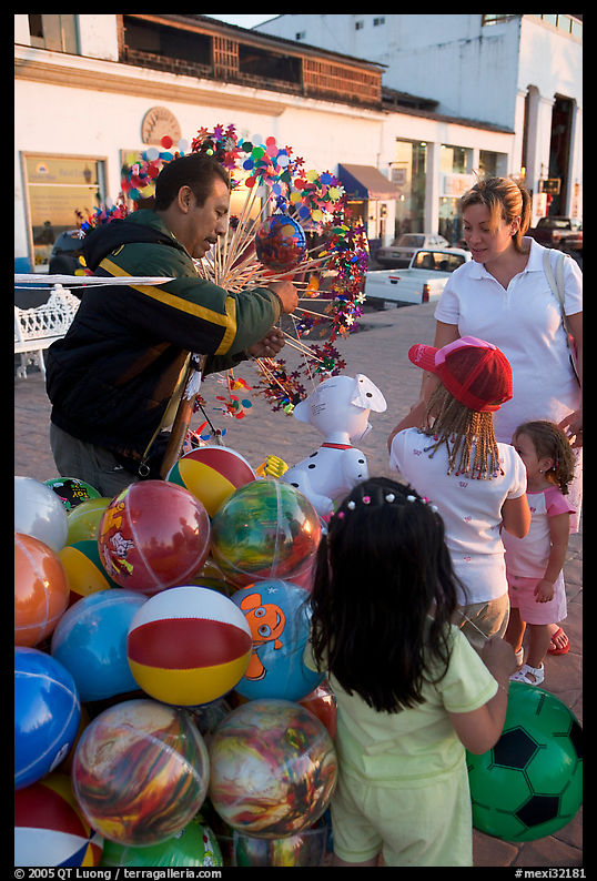 Children, mother, and balloon vendor , Puerto Vallarta, Jalisco. Jalisco, Mexico