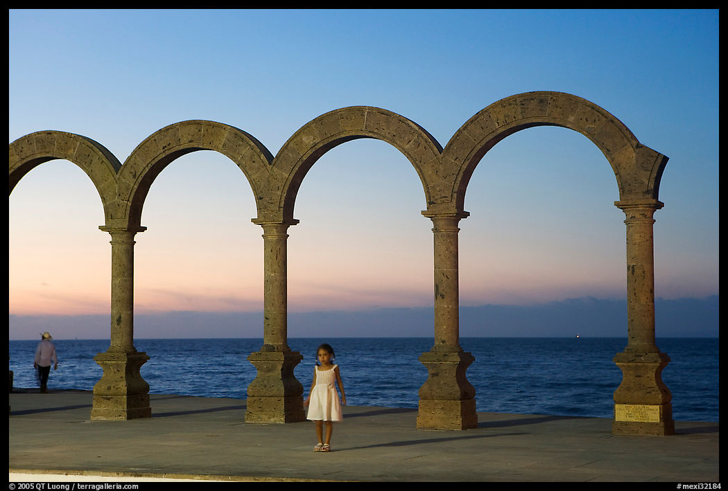 Girl standing by the Malecon arches at sunset, Puerto Vallarta, Jalisco. Jalisco, Mexico