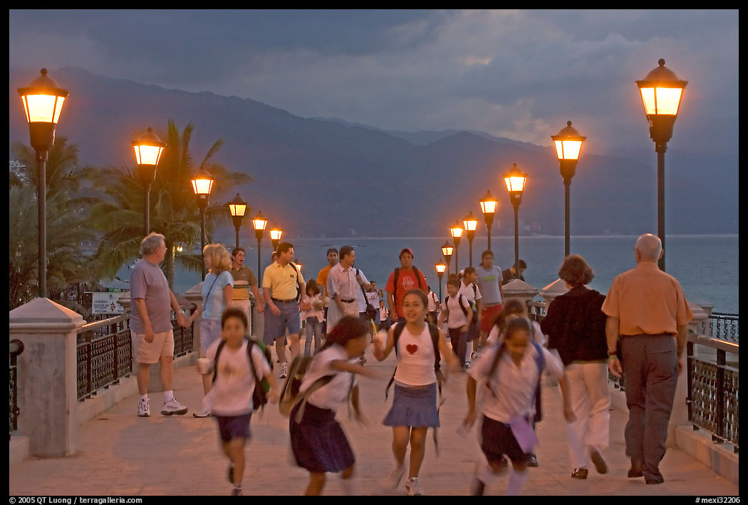 Children running on footbridge above Rio Cuale at dusk, Puerto Vallarta, Jalisco. Jalisco, Mexico