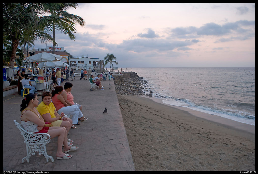 Women sitting on a bench looking at the ocean, Puerto Vallarta, Jalisco. Jalisco, Mexico