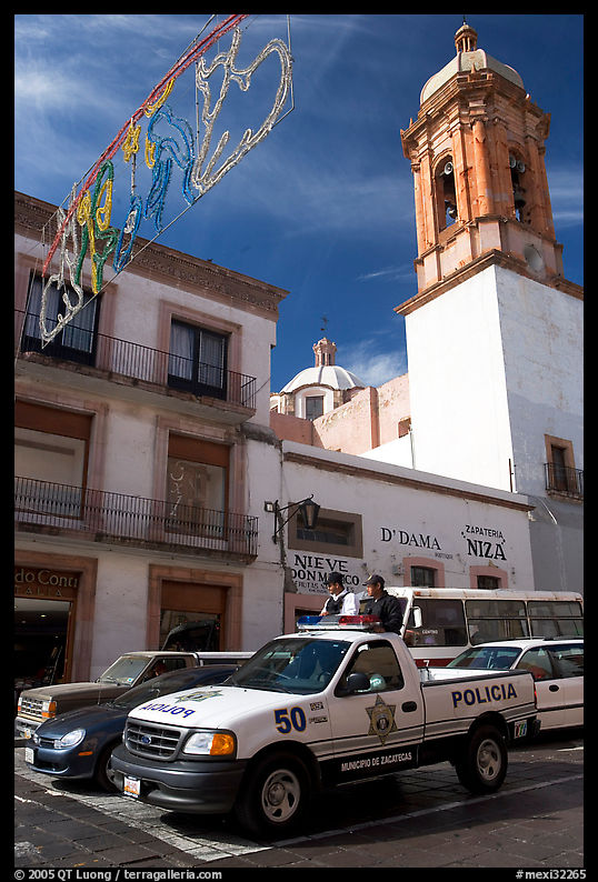 Policemen riding in the back of a pick-up truck. Zacatecas, Mexico