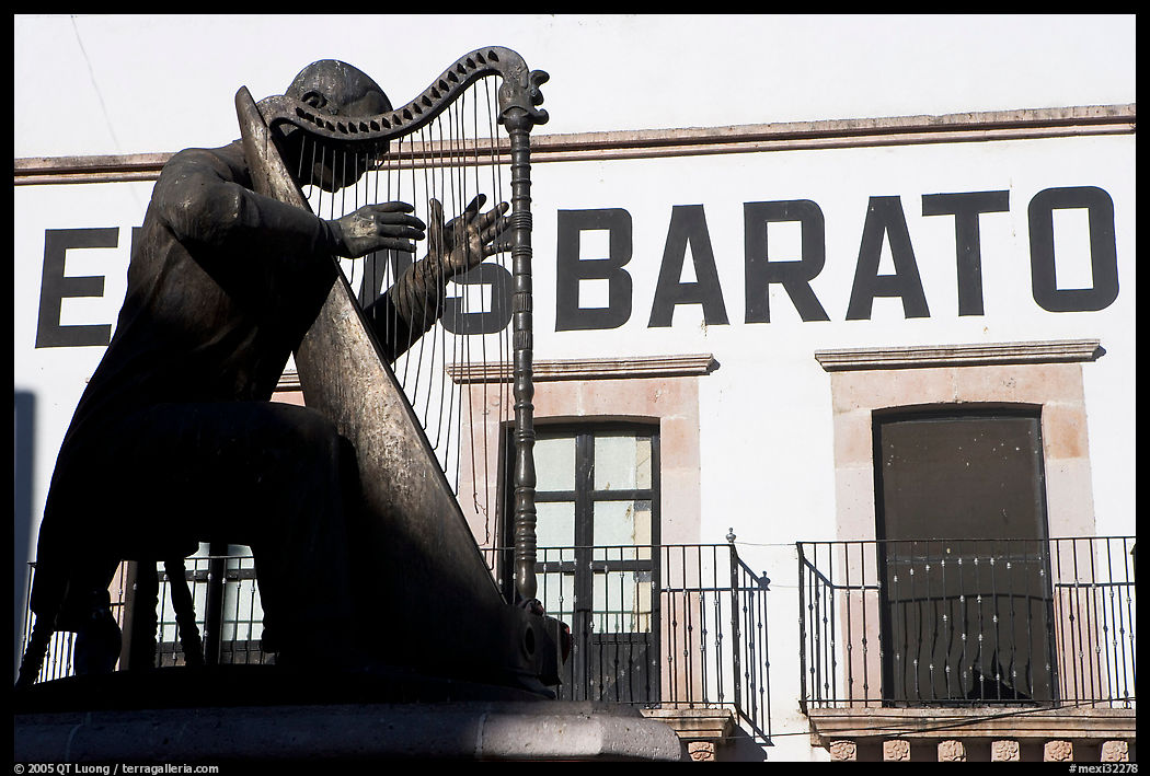 Statue of a musician and house with inscriptions. Zacatecas, Mexico