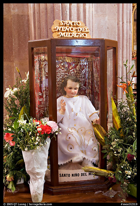 Figure of Santo Nino Del Milagro with offered flowers. Zacatecas, Mexico