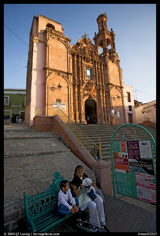 Woman and child waiting for bus below a church. Guanajuato, Mexico