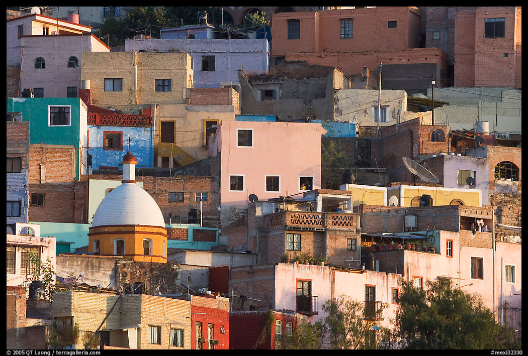 Multicolored houses on a steep hillside, late afternoon. Guanajuato, Mexico