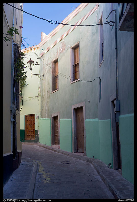 Narrow street with green houses. Guanajuato, Mexico