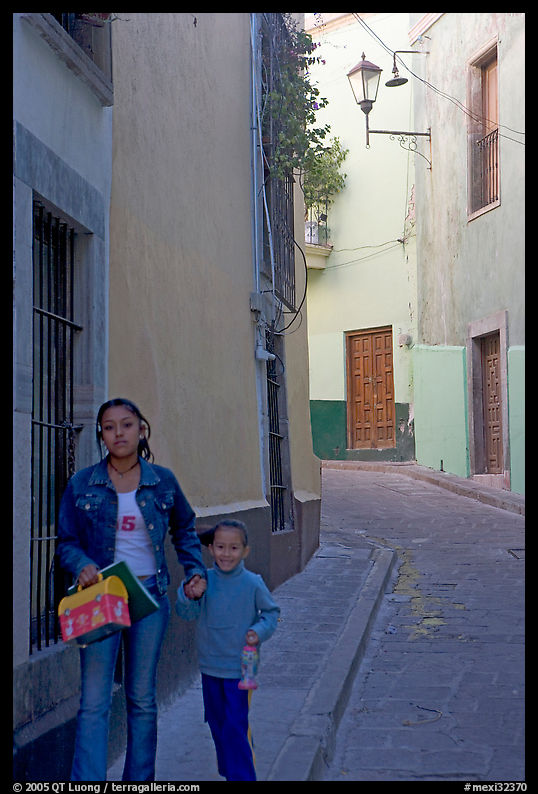Woman and child walking in a narrow street. Guanajuato, Mexico