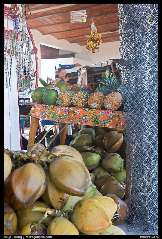 Tropical Fruit stand with girl in background. Mexico