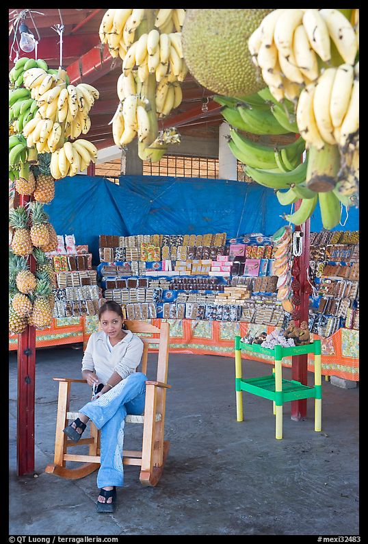 Woman sitting in a fruit stand. Mexico
