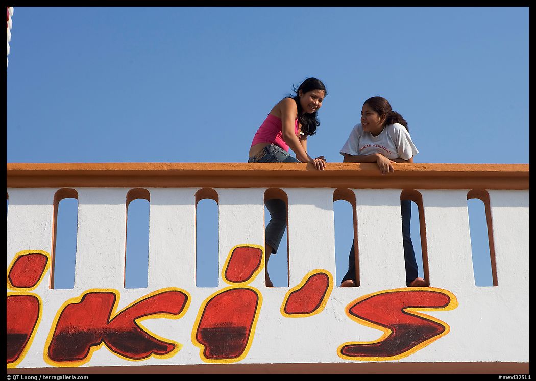 Young women sitting on a roof. Mexico