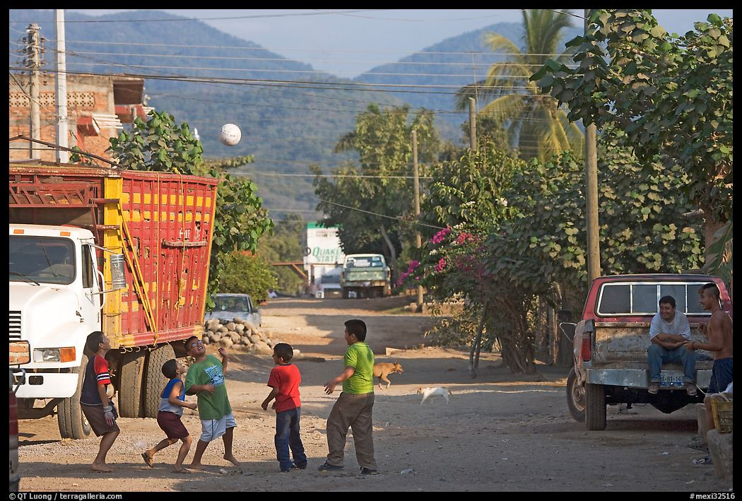 Children playing with a ball in village street. Mexico