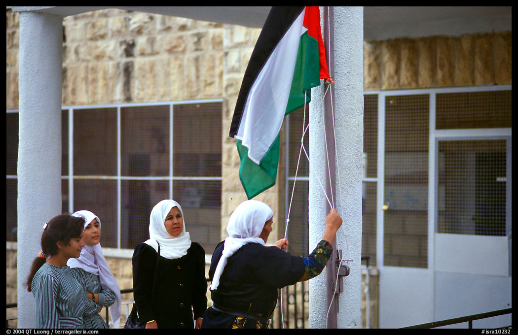 Women raise the Palestian flag at a school in East Jerusalem. Jerusalem, Israel