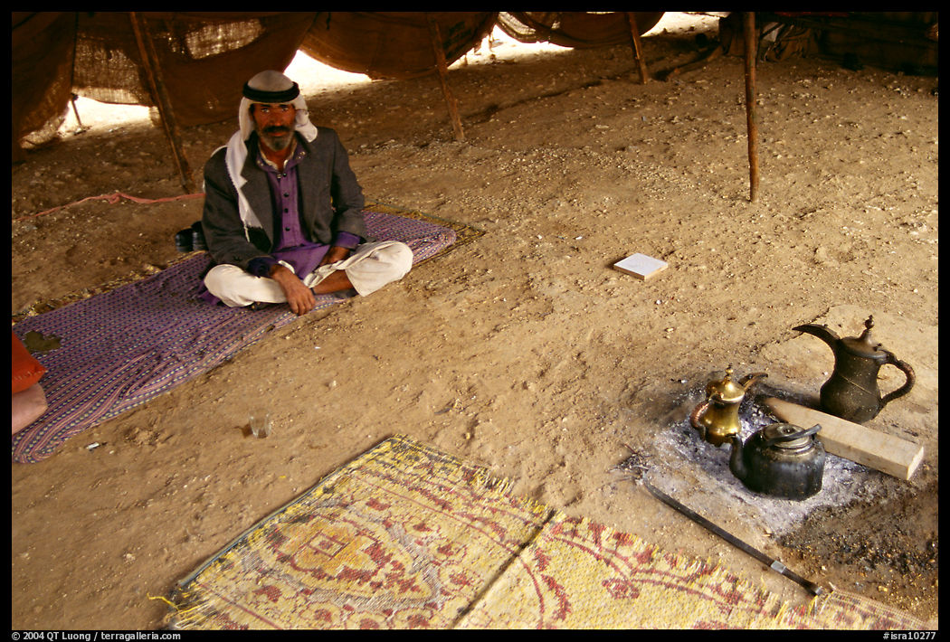 Bedouin man sitting on a carpet in a tent, Judean Desert. West Bank, Occupied Territories (Israel)