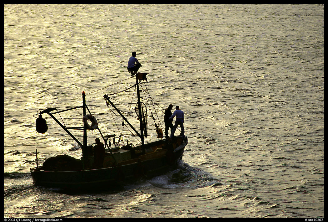 Small fishing boat silhouetted, late afternoon, Akko (Acre). Israel