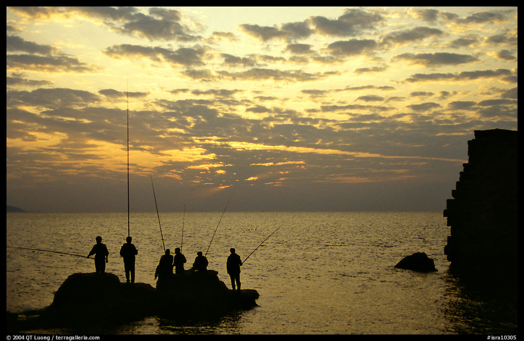 Fishermen standing on a rock, Akko (Acre). Israel