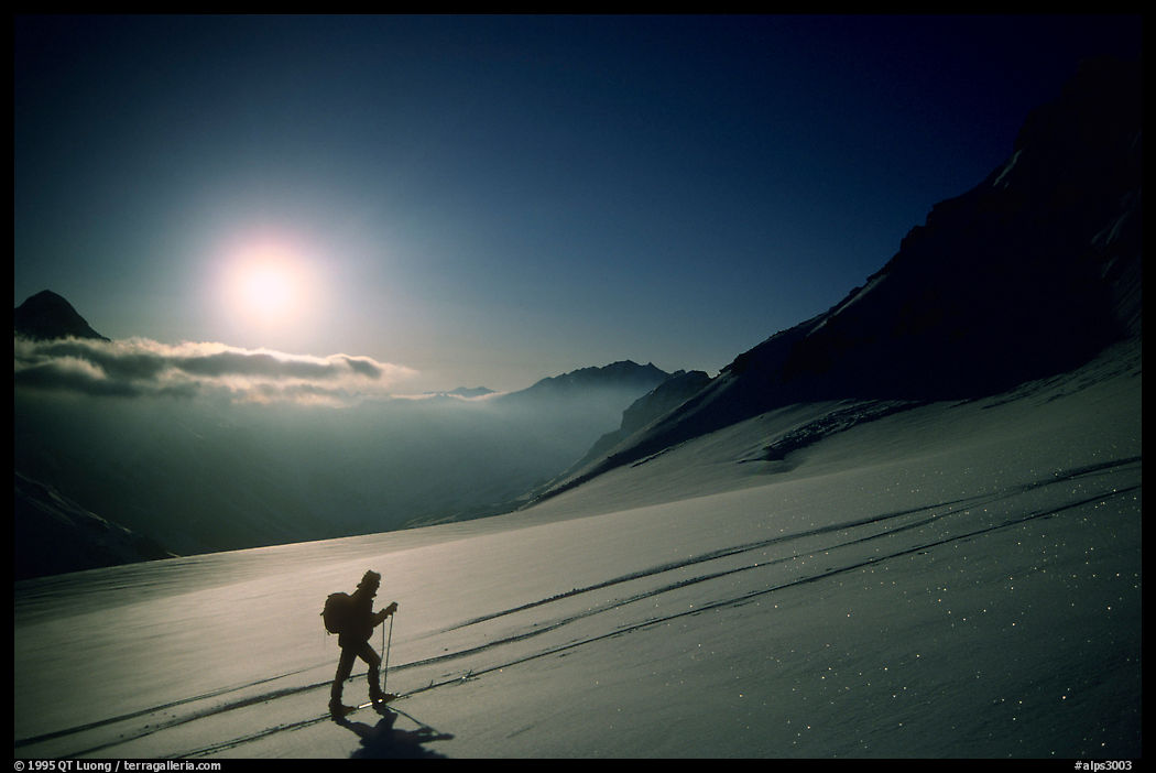 Backcountry skier climbs Dome de Chasseforet in the Vanoise Range, French Alps.