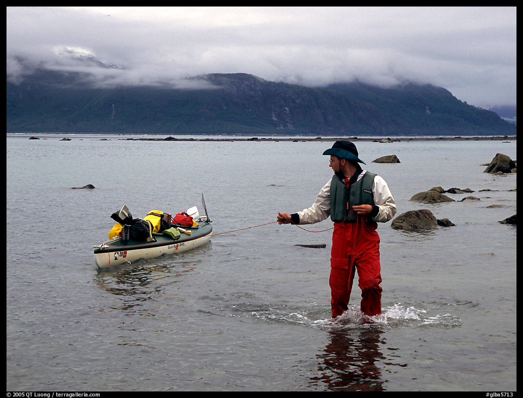 Kayaker tows kayak near Scidmore Bay. Glacier Bay National Park, Alaska