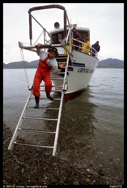 Kayaker comes down Glacier Bay Lodge concession boat for a drop-off. Glacier Bay National Park, Alaska