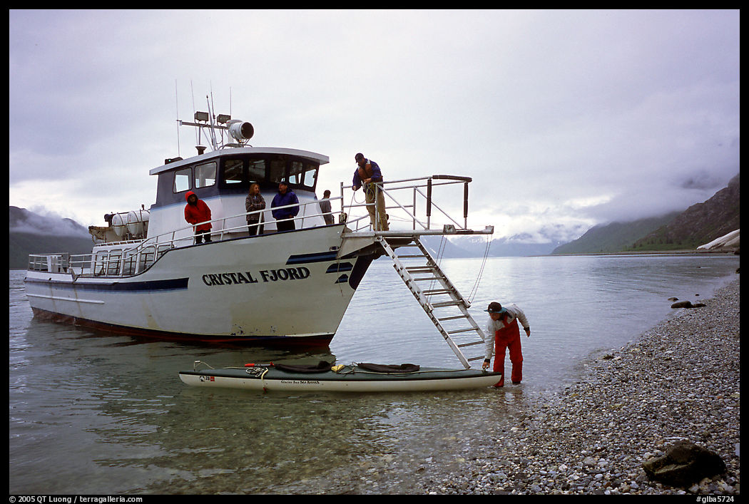 Kayaker retrieving kayak after drop-off. Glacier Bay National Park, Alaska