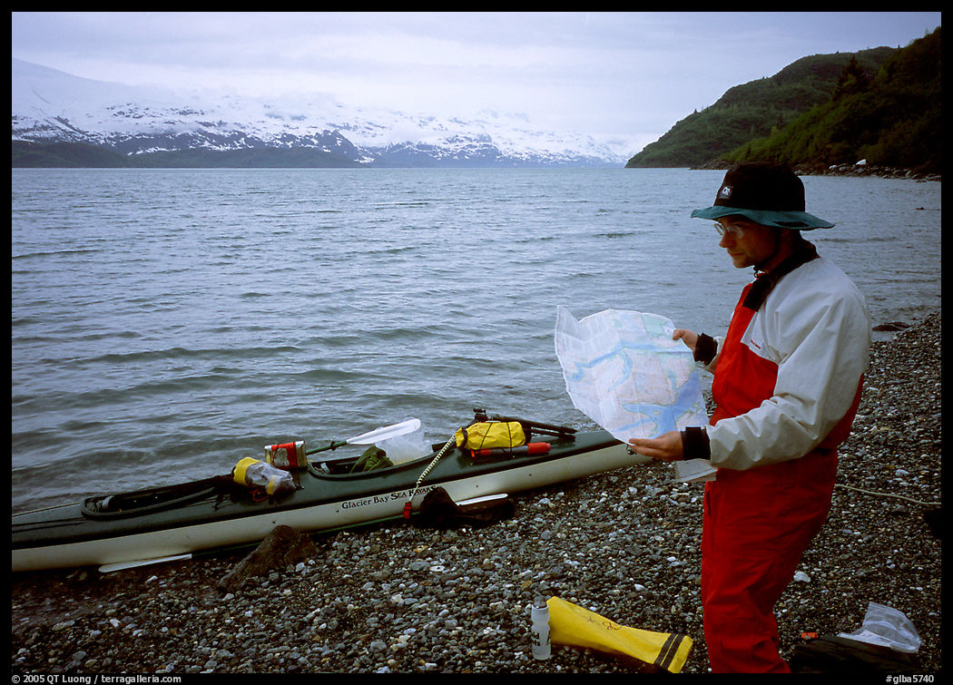 Kayaker looking at the map, East Arm. Glacier Bay National Park, Alaska