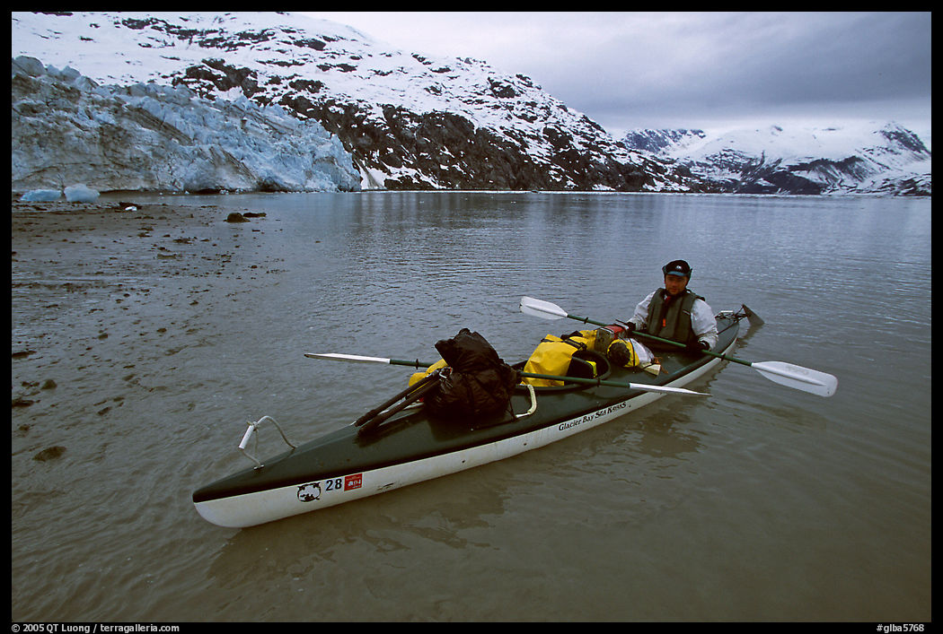 Kayaker sitting in loaded double kayak near Lamplugh Glacier. Glacier Bay National Park, Alaska