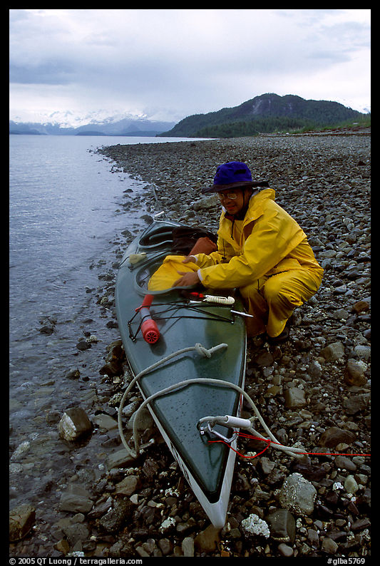 Kayaker unloading kayak. Glacier Bay National Park, Alaska
