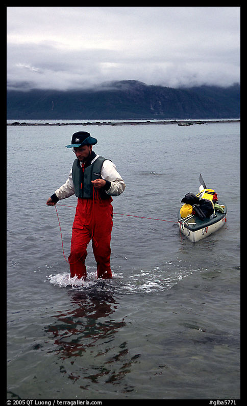 Kayaker towing kayak, East arm. Glacier Bay National Park, Alaska