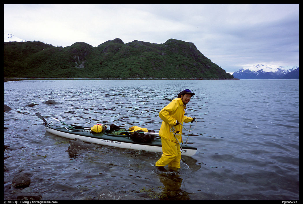 Kayaker towing kayak, East arm. Glacier Bay National Park, Alaska