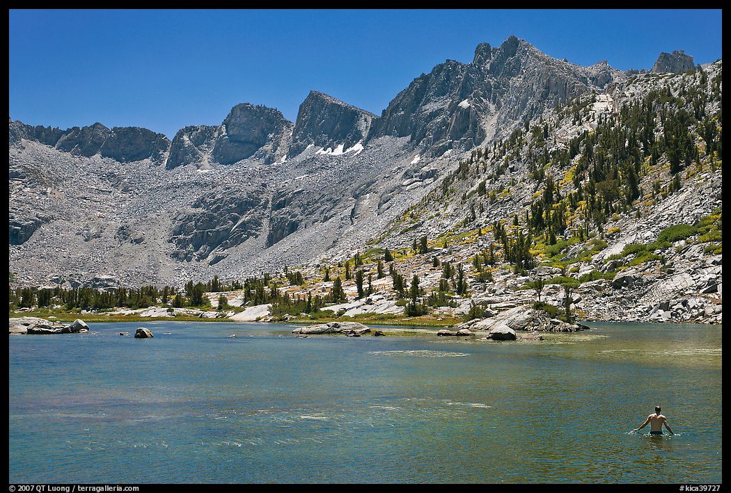 Man bathing in alpine lake, lower Dusy Basin. Kings Canyon National Park, California