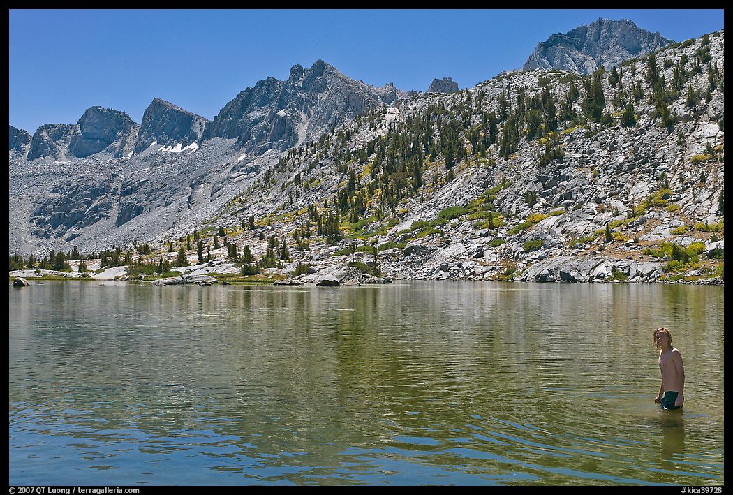 Young man in alpine lake, lower Dusy Basin. Kings Canyon National Park, California
