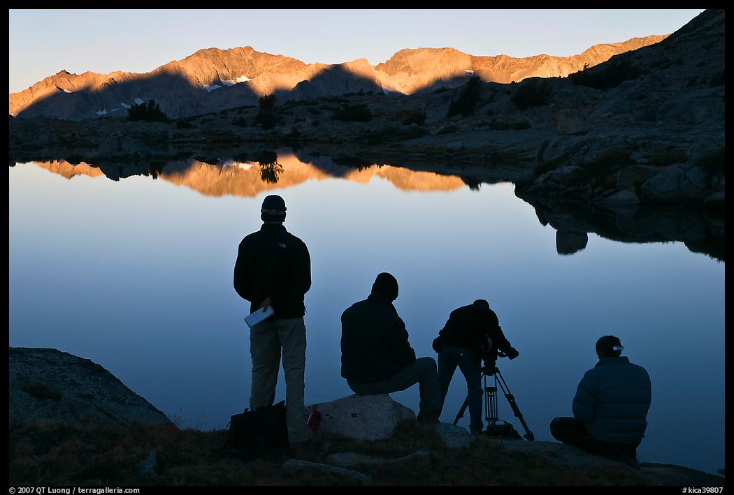 Film crew in action at lake, sunrise, Dusy Basin. Kings Canyon National Park, California