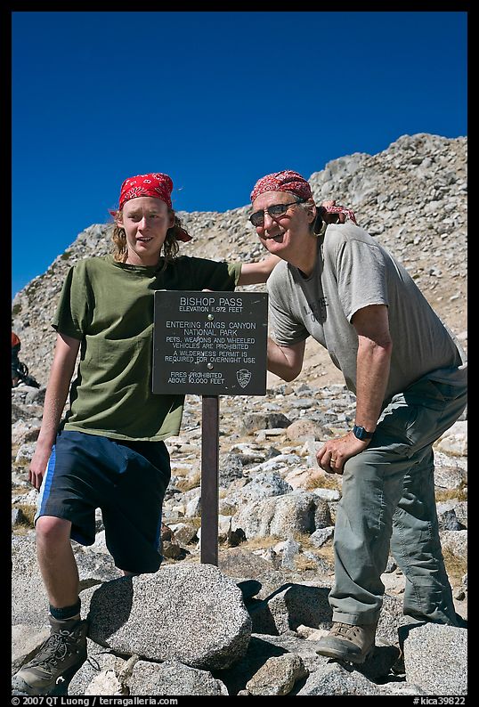 Father and son standing next to Bishop Pass sign. Kings Canyon National Park, California