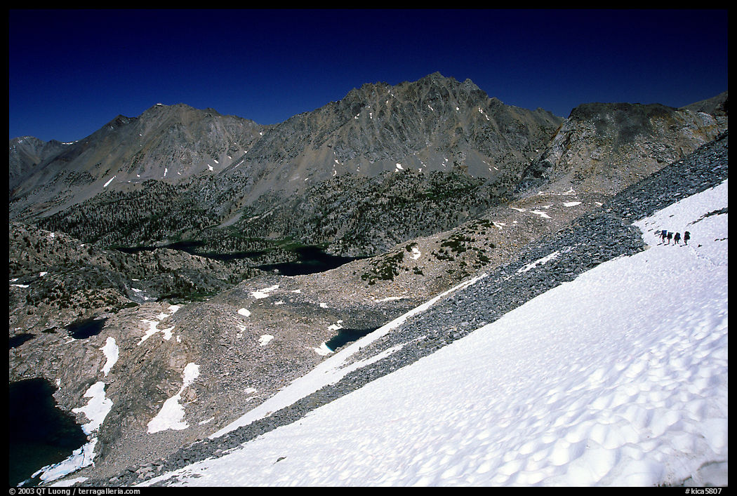 Backpackers on a snow field at a high pass. Kings Canyon National Park, California