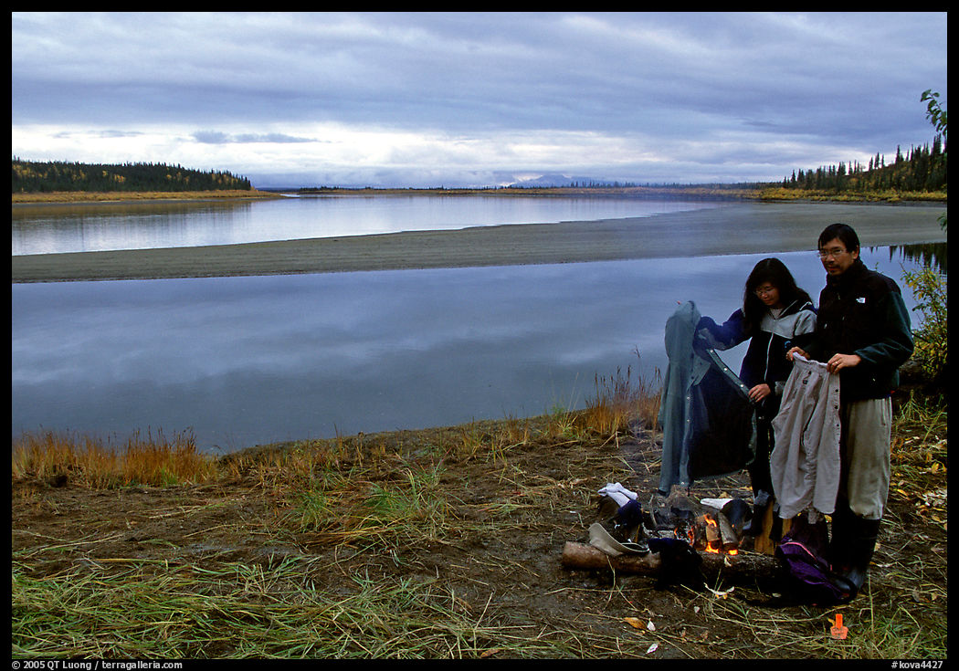 Canoeist drying out clothing over a campfire. Kobuk Valley National Park, Alaska