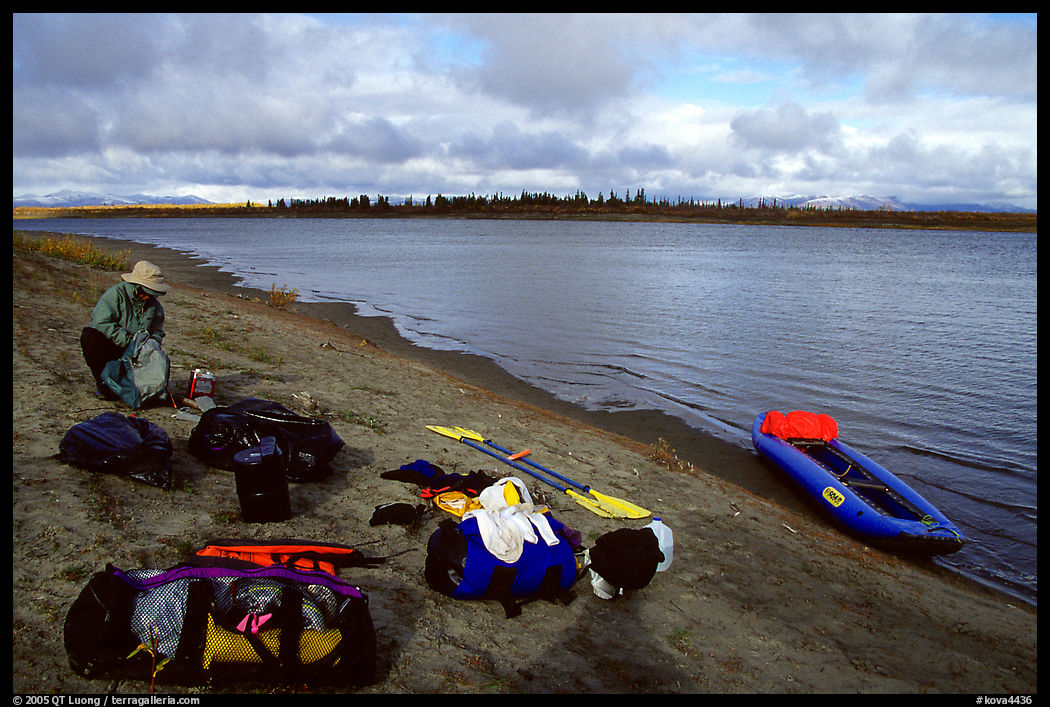 Canoeist packing the camping gear. Kobuk Valley National Park, Alaska