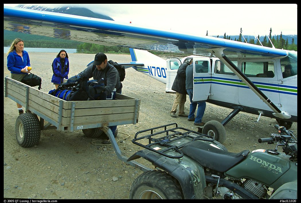 Unloading the gear from the plane to a trailer on the Port Alsworth airstrip. Lake Clark National Park, Alaska